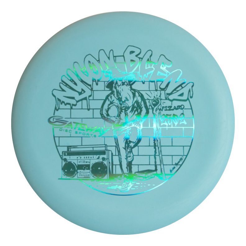 The Wizard - Suregrip Nylon is a light blue stable putter featuring a hoodie-clad figure holding a disc, brick wall, boombox, and the text €œWYLDBLEMS€� and €œGateway Disc Sports Wizard€�€”ideal for mid-range drives.