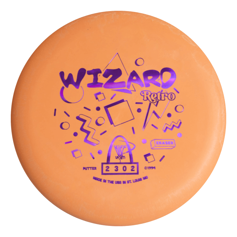 The Retro Wizard - Eraser is an orange disc golf putter from the Retro series, featuring purple geometric patterns and text on the front€”ideal for fans of distinctive putters.