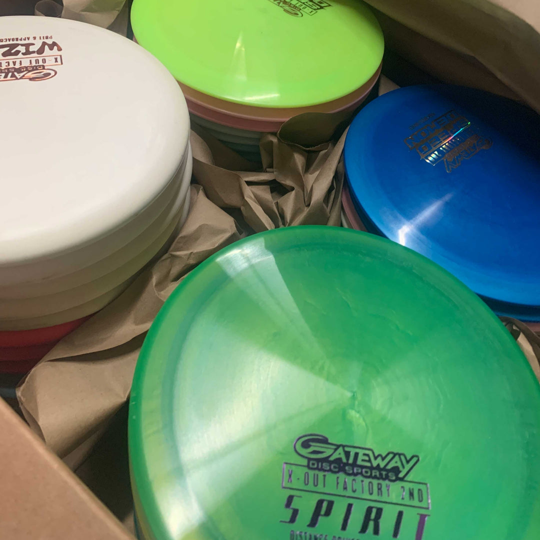 The Gateway Factory 2nd Mystery 55-Pack is a box of assorted disc golf discs: mid-ranges, drivers, and putters in various colors and brands.