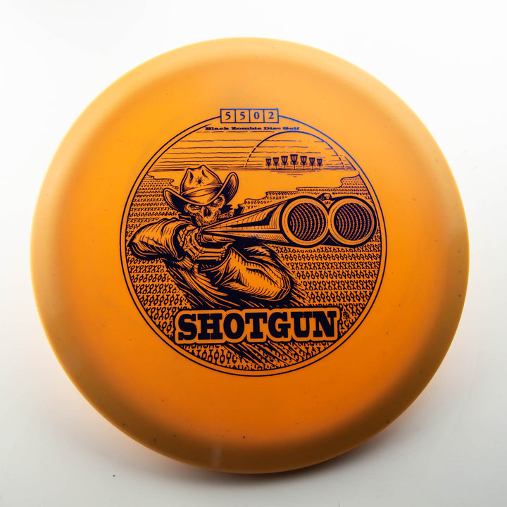 The Black Zombie Shotgun — Platinum is an orange disc golf disc featuring a cowboy aiming a shotgun, with "SHOTGUN" printed below the illustration.