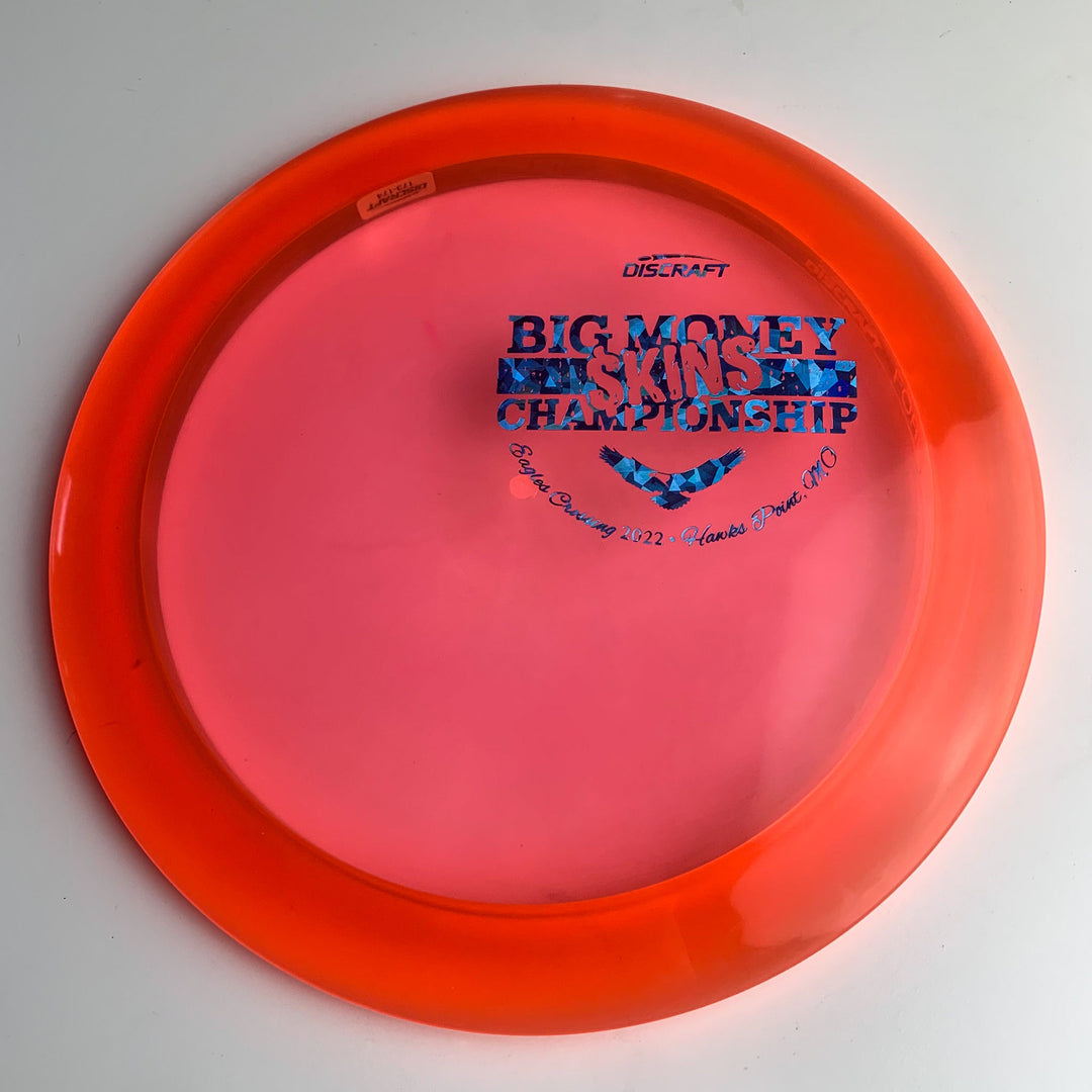 A bright red EC Discraft - Force disc golf disc with "Skins Championship" and Eagles Crossing event details printed in blue on top, commemorating the tournament.