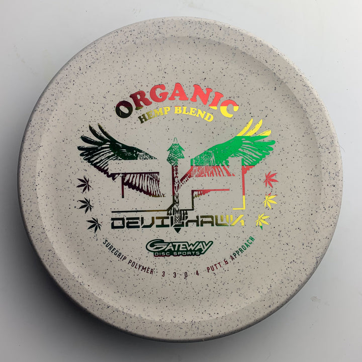 The Devilhawk - Suregrip Hemp is a white speckled, overstable putter with colorful —Organic Hemp Blend—� and —Devilhawk—� graphics, plus Gateway Disc Sports' distinctive Thumb Track design.