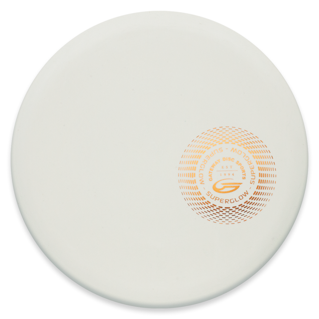 The Element - Suregrip Superglow is a white, round disc featuring an orange circular logo and "Superglow" text, crafted for reliable mid-range throws with straight flight and impressive glide.