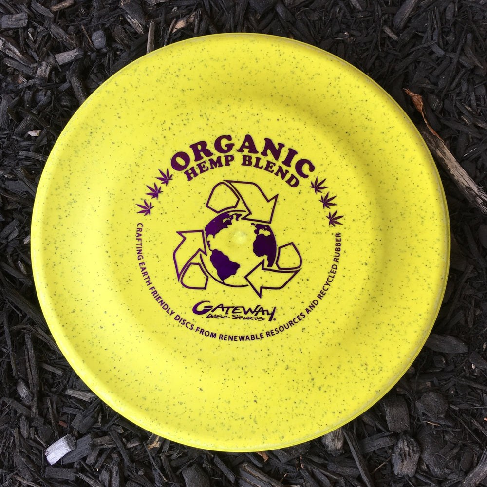 The Organic Hemp Catch Sport Disc, in yellow with purple "Organic Hemp Blend" text and a globe with recycling arrows, is perfect for outdoor fun or Dog-Sport enthusiasts.