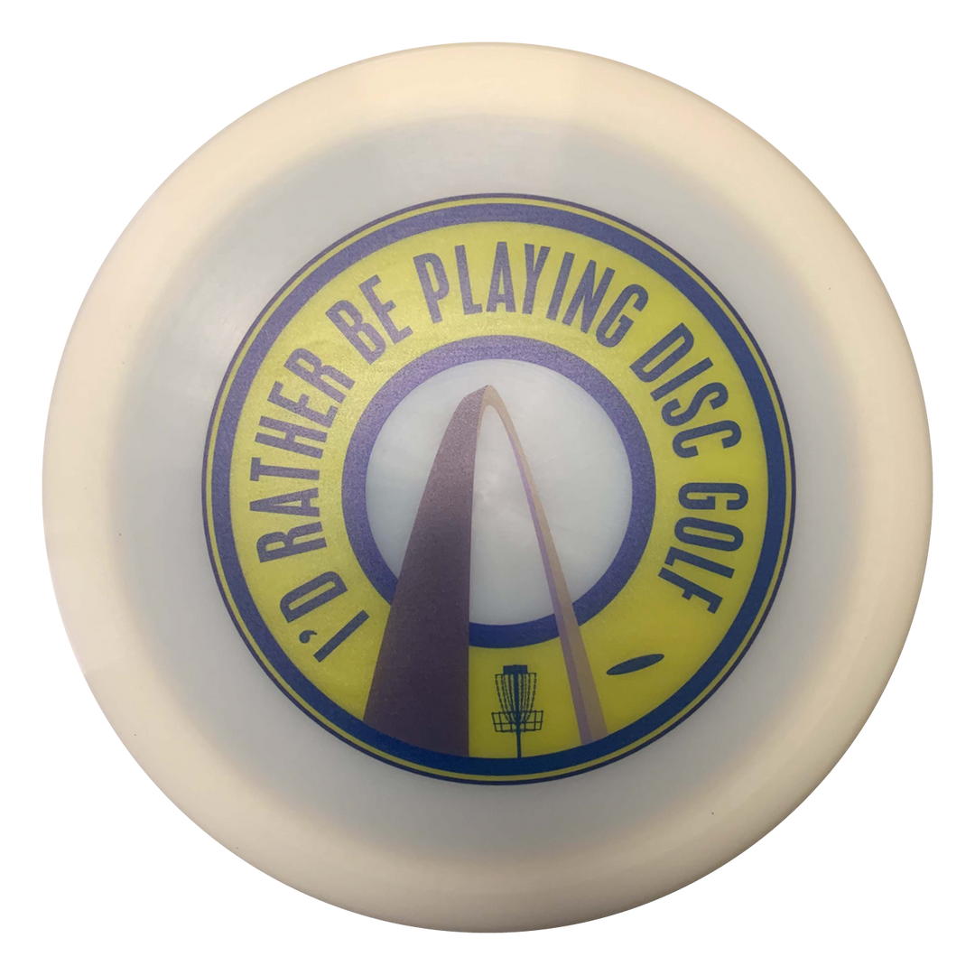 The St. Louis Hockey Full Color Drivers is a white disc golf disc featuring a yellow and blue "I'D RATHER BE PLAYING DISC GOLF" graphic with a disc golf basket and arch inspired by St. Louis hockey—ideal for fans of fairway drivers.