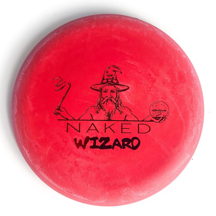 The Wizard - NAKED - Eraser is a red over-stable disc golf disc featuring a wizard with a staff and crystal ball, "NAKED WIZARD" text below—an ideal choice for fans seeking a unique Naked Wizards collectible.