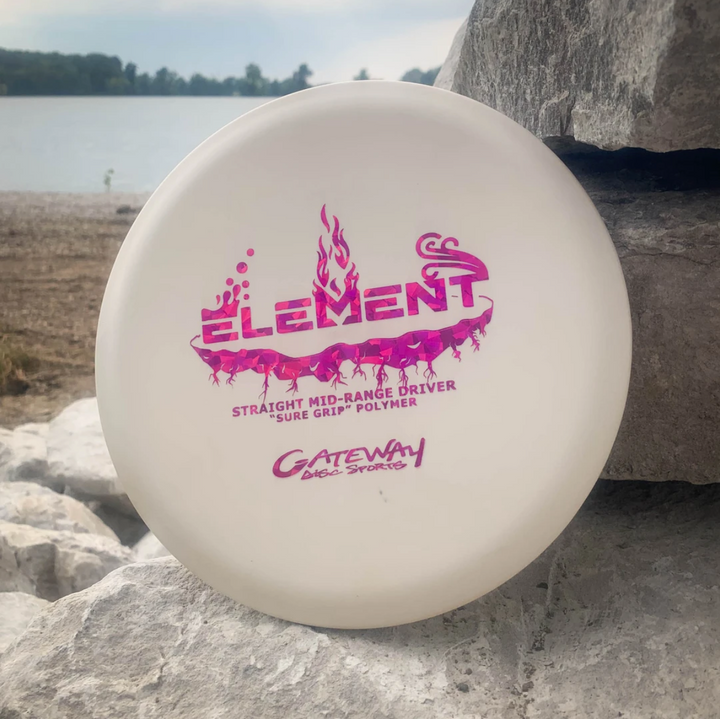 A white Element - SureGrip mid-range disc golf disc with pink branding, known for excellent glide, rests on rocks near a lake.