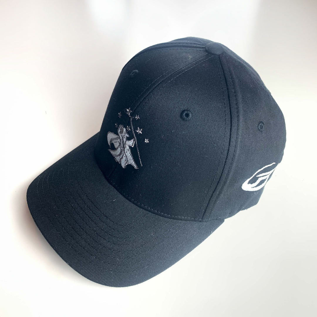 The Wizard Flexfit Fitted Hat features a black design with an embroidered Mini-Wizard logo and stars on the front and a Wizard bar stamp logo on the side, shown displayed on a white surface.