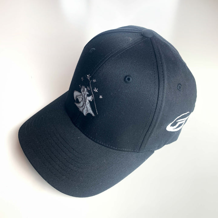 The Wizard Flexfit Fitted Hat features a black design with an embroidered Mini-Wizard logo and stars on the front and a Wizard bar stamp logo on the side, shown displayed on a white surface.