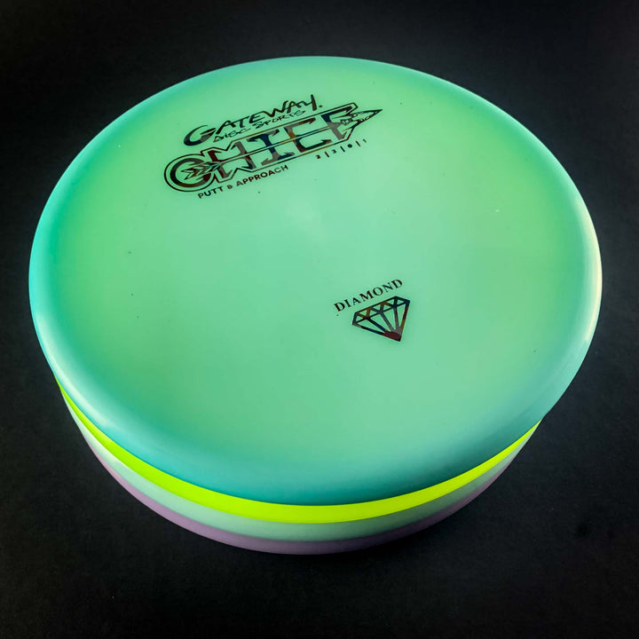 A stack of Putt & Approach disc golf putters sits on a dark background, with the top off-the-tee putter labeled "Chief - Diamond" and featuring a diamond symbol.