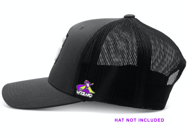 A black mesh trucker hat with a colorful Wizard Hat Pin attached to the side using a butterfly clutch; "HAT NOT INCLUDED" appears in purple below.