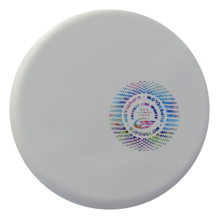 The Mystic - SureGrip™ Superglow is a white disc golf disc featuring a colorful circular pattern and “Superglow” text, designed for effortless straight flights and dependable glide.