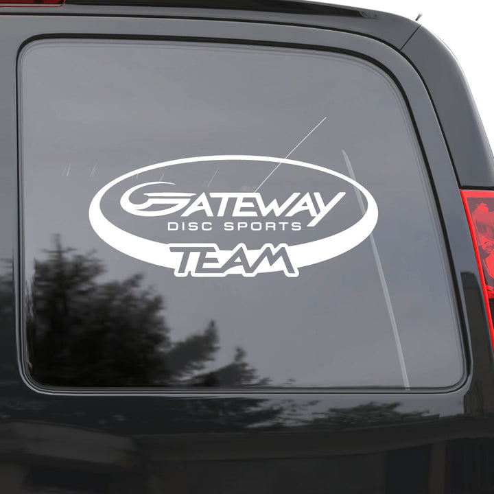 A Gateway Disc Sports Team Window Decal in white vinyl is shown on the rear side window of a dark car, reflecting trees and sky.