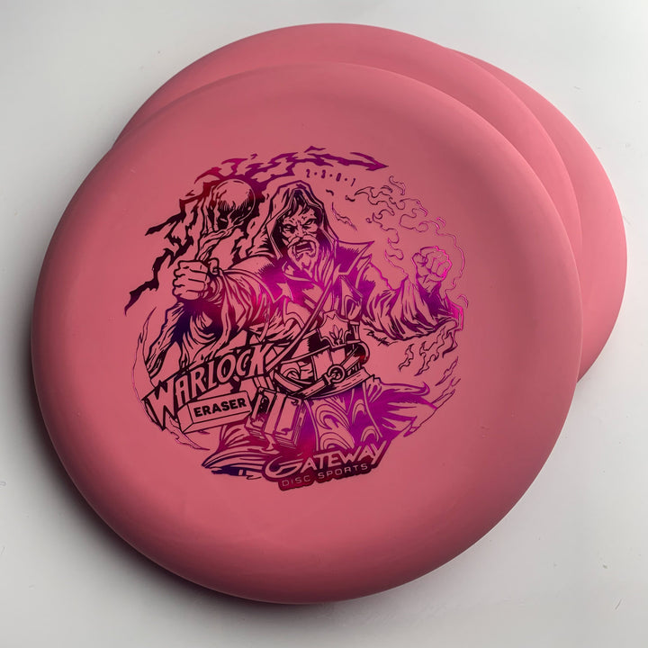 Three pink Warlock - Eraser - Brian Allen disc golf putters are stacked, with a black wizard illustration and "Warlock Eraser Gateway Disc Sports" on the top disc.