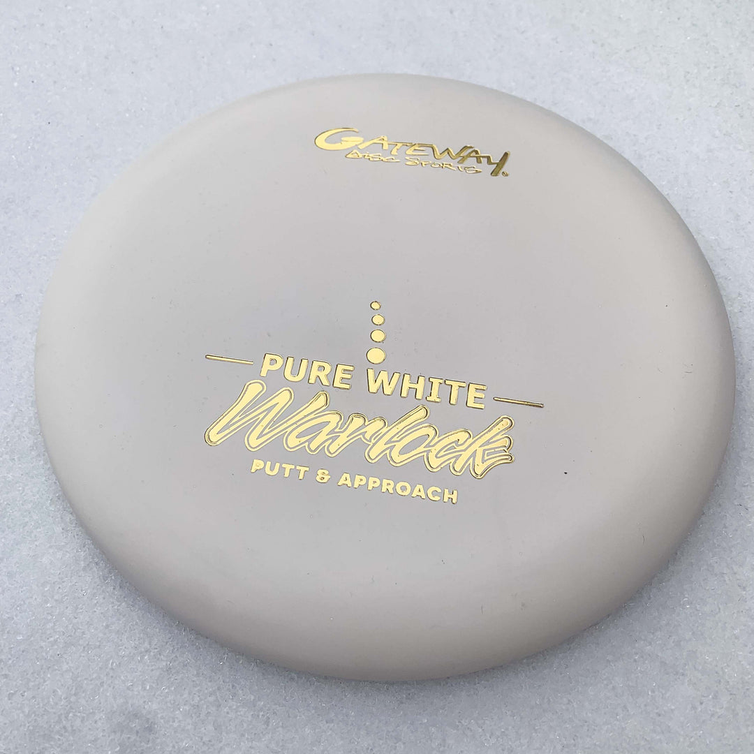 The Warlock - Pure White by Gateway, with gold lettering and marked "Putt & Approach," is displayed on a light surface€”ideal for fans of the Warlock or Wizard series.
