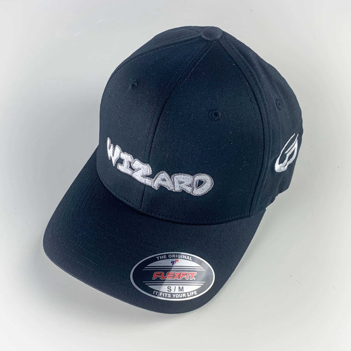 The Wizard Flexfit Fitted Hat features "WIZARD" embroidered in white on the front, a Wizard bar stamp on the side, and offers a comfortable fit—perfect for any Mini-Wizard enthusiast.